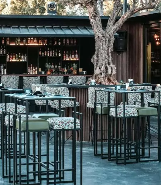 Outdoor bar with fabricated steel stools and counters